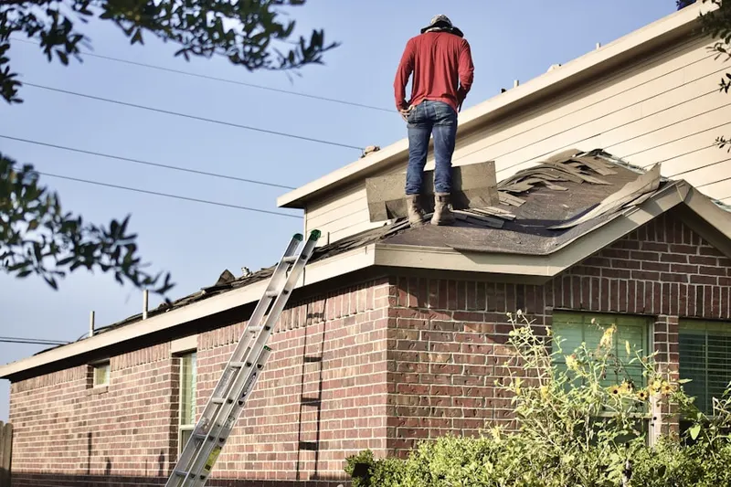 Professional roofer working on a residential roof in Hoodview
